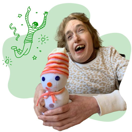 A woman holding a sock snowman