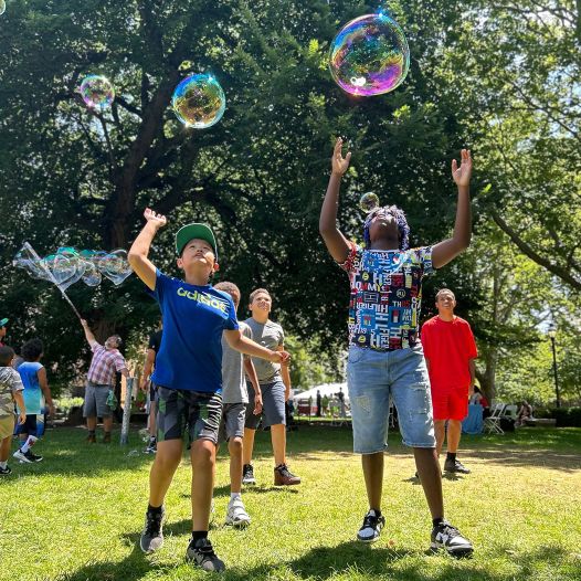 Kids playing with bubbles outside