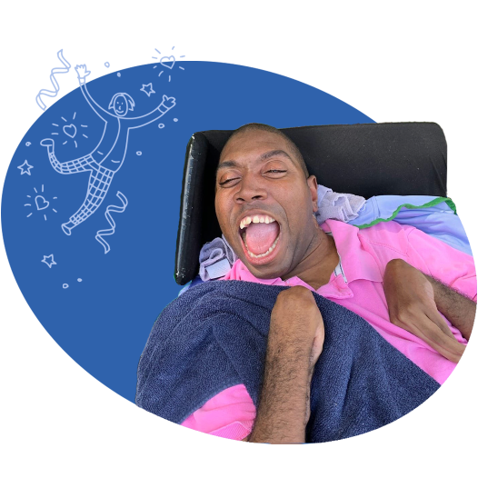 A man in a wheelchair smiling 