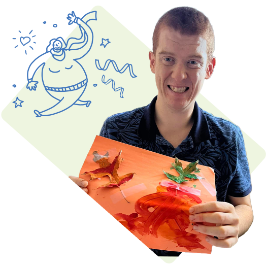 A man holding up his drawing and smiling