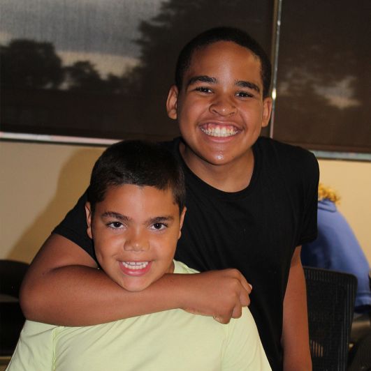 Two young boys smiling and posing