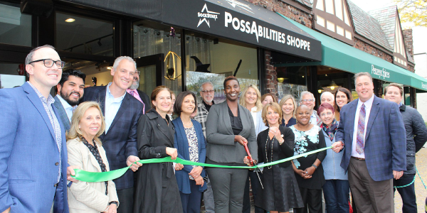 A large group of people at a ribbon cutting event