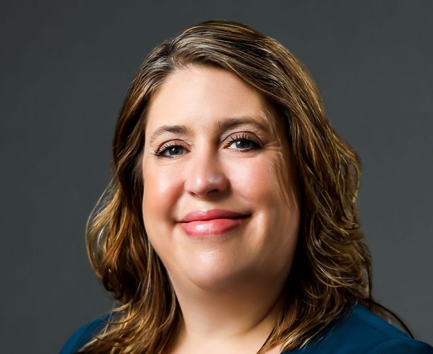 A headshot of a woman with blonde brown hair